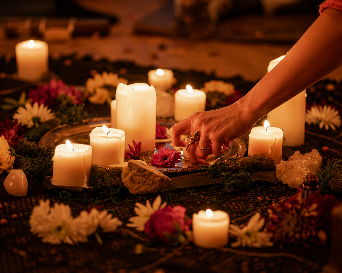 Women sitting in a circle around a candlelit altar